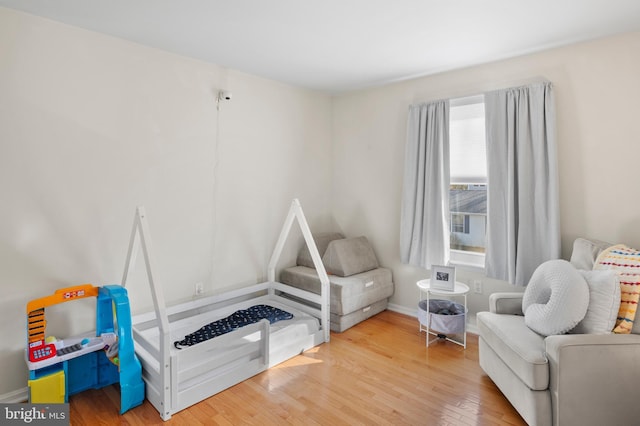 interior space featuring baseboards and wood finished floors