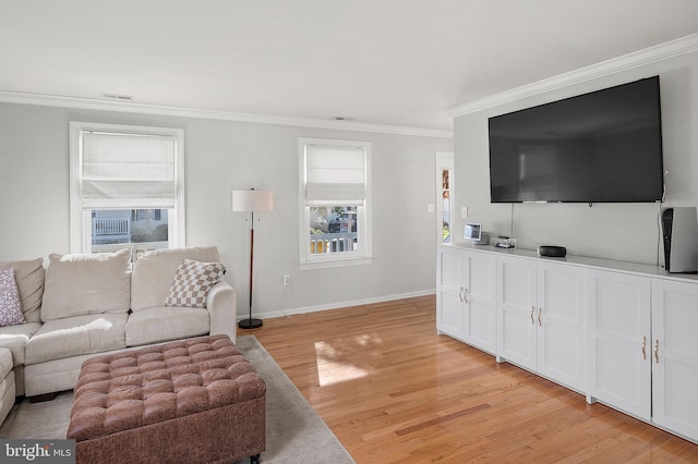 living area with visible vents, light wood-style floors, baseboards, and ornamental molding