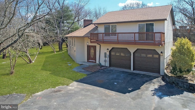 view of front of house featuring aphalt driveway, a front yard, a shingled roof, a garage, and a chimney