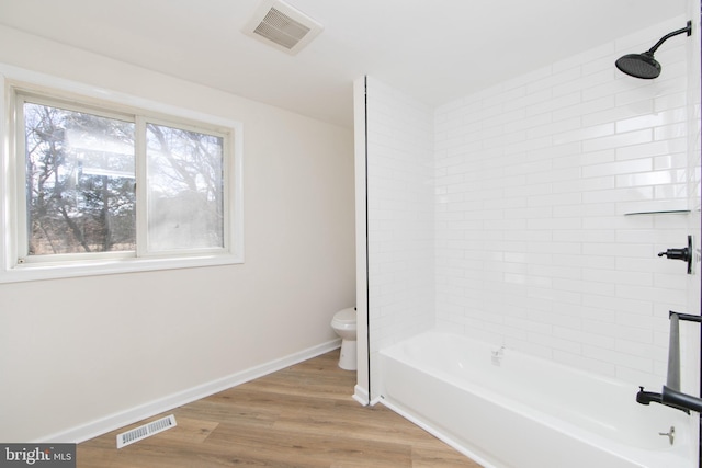 bathroom with visible vents, baseboards, toilet, and wood finished floors