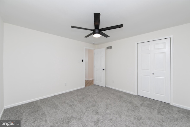 unfurnished bedroom with visible vents, baseboards, carpet, and a closet