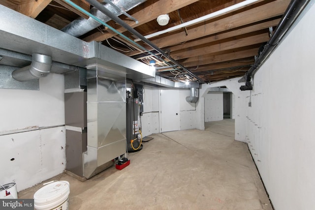 unfinished basement featuring heating unit and water heater