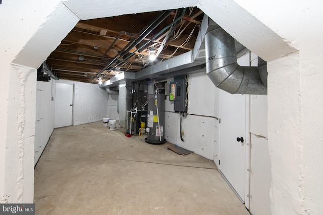 unfinished basement featuring electric panel, heating unit, and water heater