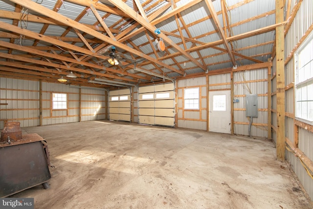 garage with electric panel and metal wall