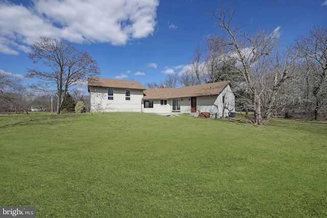 back of property with a lawn