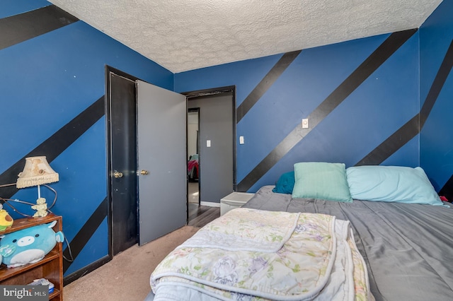 carpeted bedroom featuring a textured ceiling