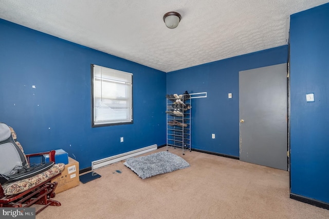 misc room featuring carpet, baseboards, baseboard heating, and a textured ceiling