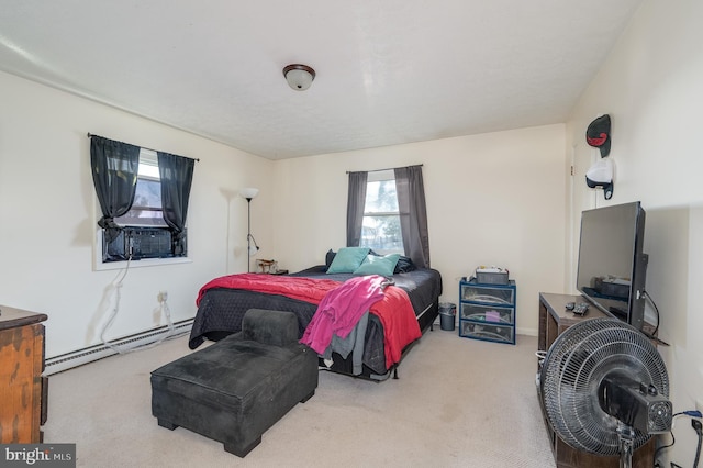 bedroom with baseboard heating and carpet flooring