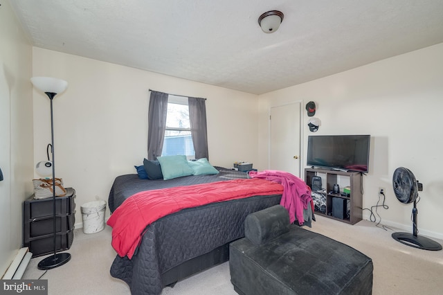 carpeted bedroom featuring baseboards and a baseboard radiator