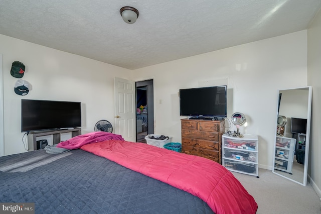 bedroom featuring baseboards, carpet, and a textured ceiling