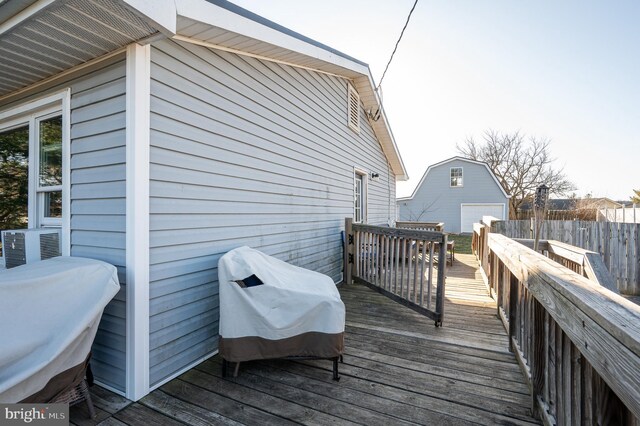 deck with an outdoor structure and fence