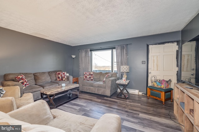 living area featuring baseboards, a textured ceiling, and wood finished floors