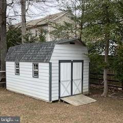 view of shed featuring fence