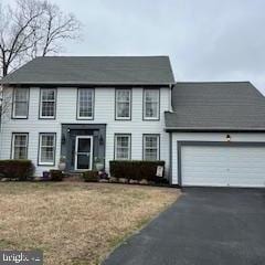 colonial house with a garage and driveway