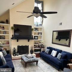 living room with vaulted ceiling and ceiling fan