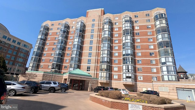 view of building exterior featuring uncovered parking