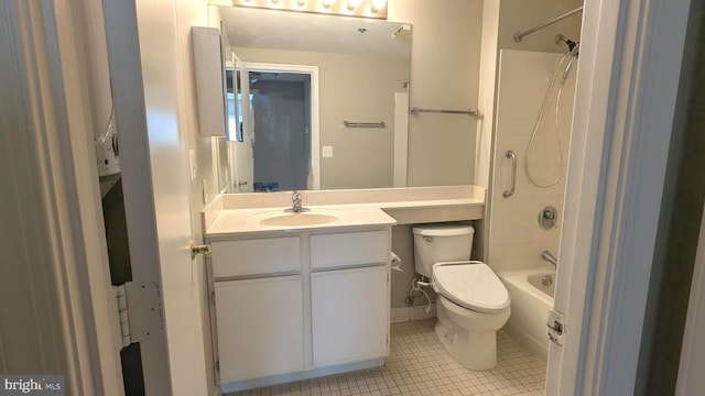 bathroom featuring tub / shower combination, toilet, vanity, and tile patterned flooring