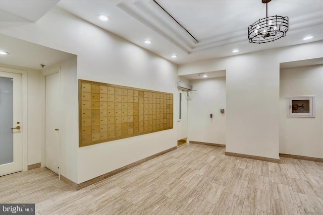 interior space featuring recessed lighting, mail area, a wall mounted AC, and baseboards