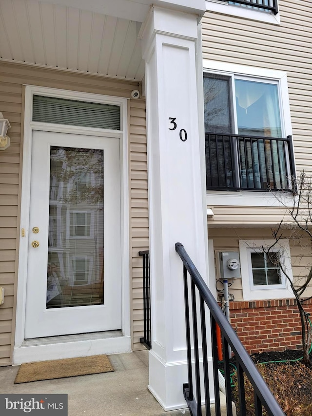 property entrance featuring brick siding