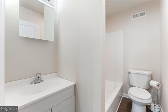 bathroom with visible vents, toilet, a tub to relax in, vanity, and a shower