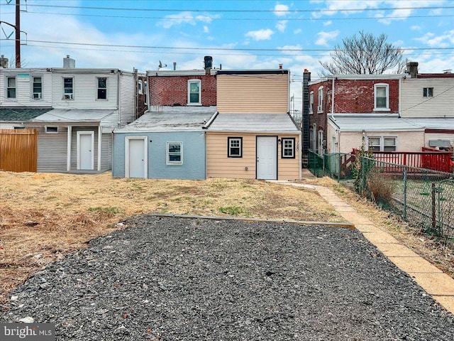 back of property with a fenced backyard