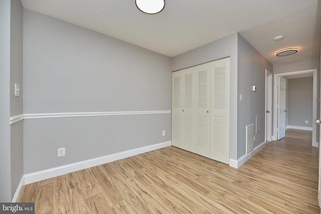 unfurnished bedroom with light wood-style floors and baseboards