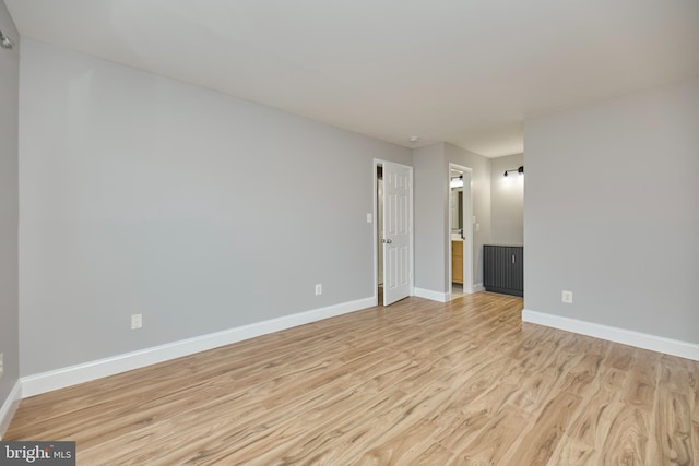 unfurnished room featuring light wood-style flooring and baseboards