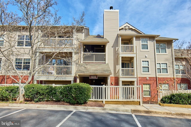 view of property featuring uncovered parking