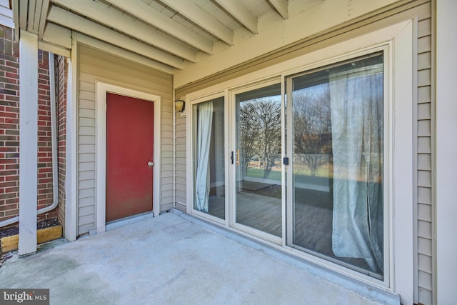 entrance to property featuring brick siding