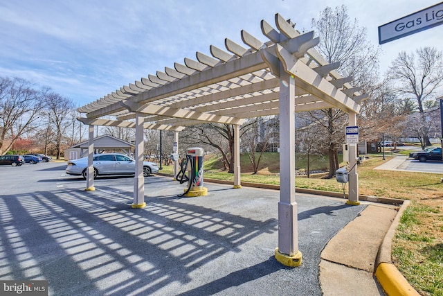 exterior space with covered parking and a pergola