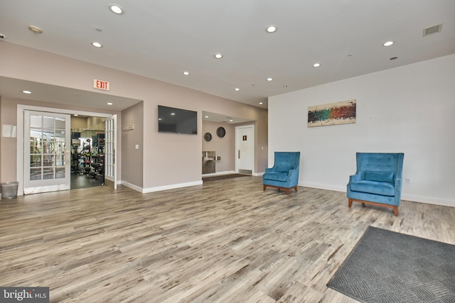 living area featuring visible vents, recessed lighting, and wood finished floors