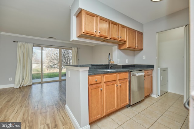 kitchen with a sink, baseboards, brown cabinets, and dishwasher