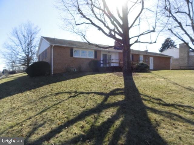 view of front of home featuring a front yard and brick siding