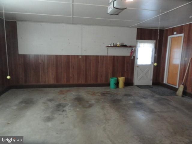 garage featuring wood walls