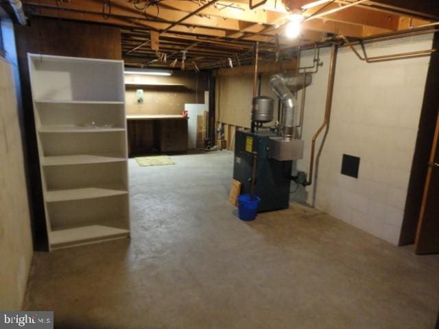 unfinished below grade area with a heating unit