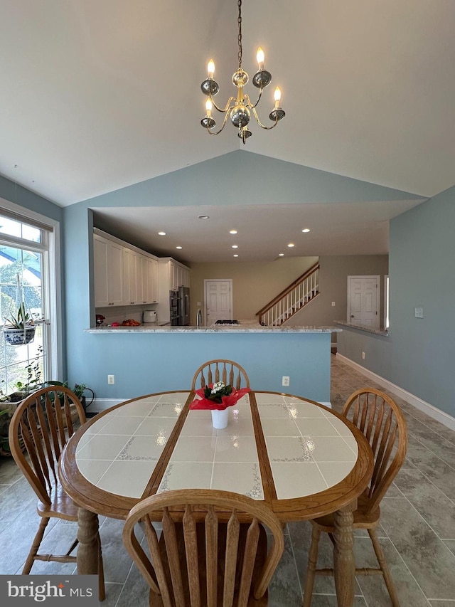 dining area with baseboards, an inviting chandelier, recessed lighting, stairs, and vaulted ceiling