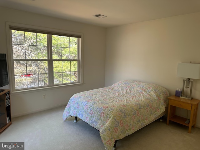 carpeted bedroom featuring baseboards