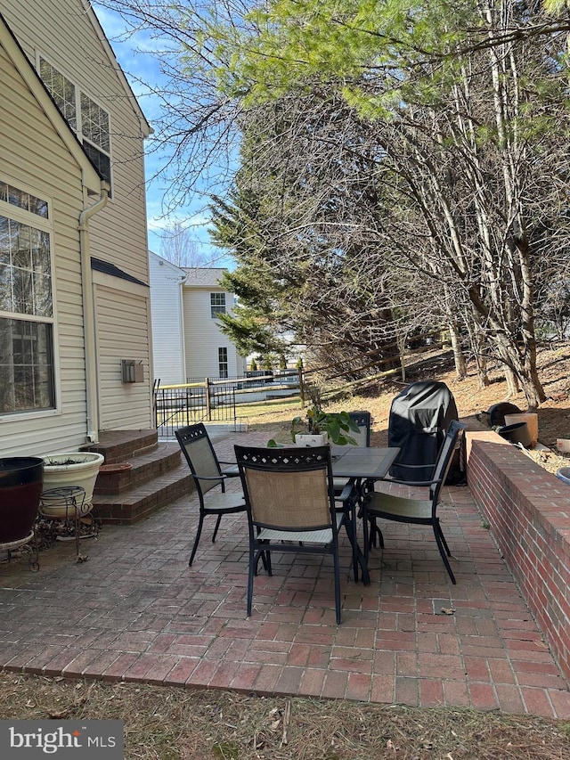 view of patio / terrace with outdoor dining space and fence