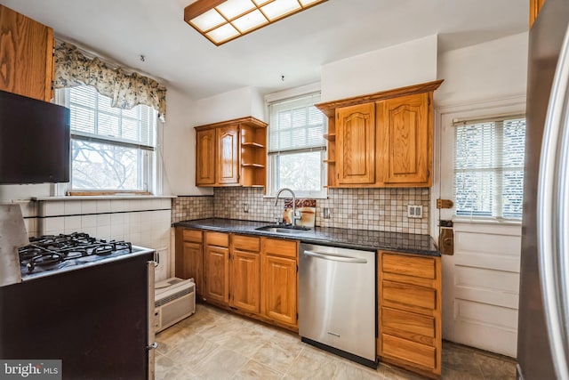 kitchen featuring a sink, brown cabinetry, appliances with stainless steel finishes, and open shelves