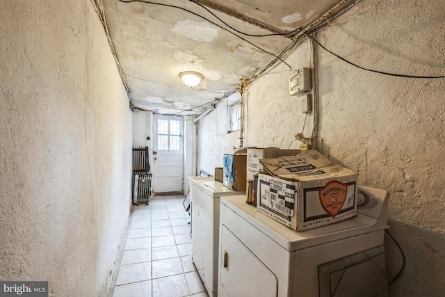 laundry area featuring washer and dryer and a textured wall
