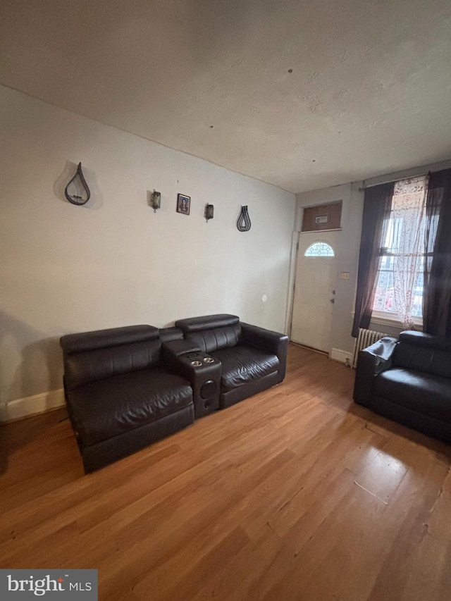 3316 Jasper St, Philadelphia, PA 19134 - living area featuring baseboards, wood finished floors, and radiator heating unit