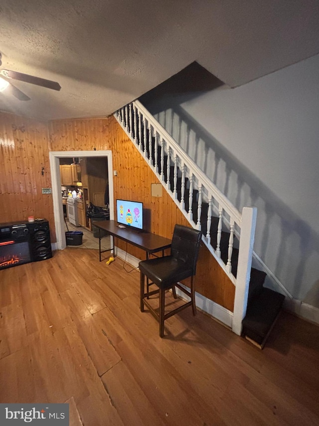 3316 Jasper St, Philadelphia, PA 19134 - sitting room with ceiling fan, stairway, wood walls, wood finished floors, and a textured ceiling