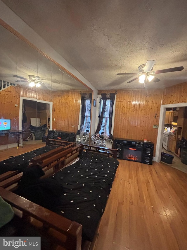 3316 Jasper St, Philadelphia, PA 19134 - miscellaneous room featuring wood finished floors, a textured ceiling, ceiling fan, and wooden walls