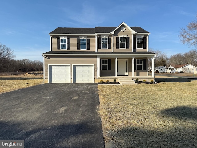 view of front facade featuring a porch, an attached garage, a front lawn, and aphalt driveway