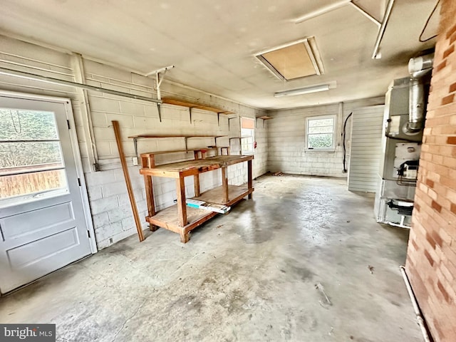 basement with concrete block wall and a garage