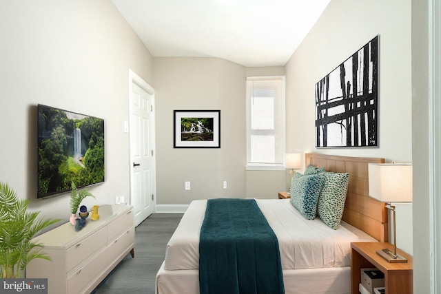 bedroom featuring baseboards and wood finished floors