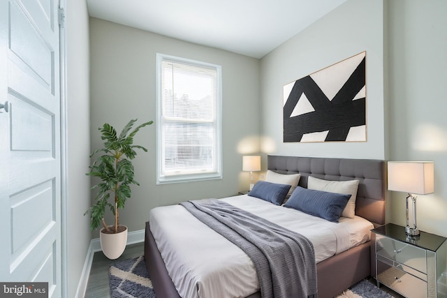 bedroom featuring wood finished floors and baseboards