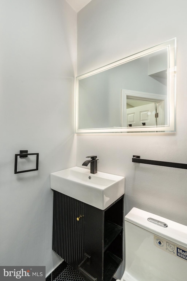 half bathroom with toilet and vanity