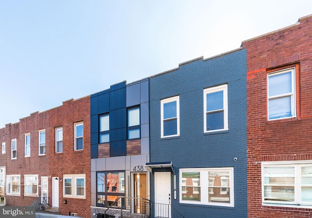 view of property with brick siding