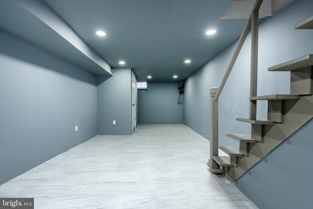 finished below grade area with stairs and recessed lighting